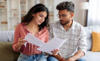 Couple analysant un prêt immobilier avec compte joint et documents bancaires